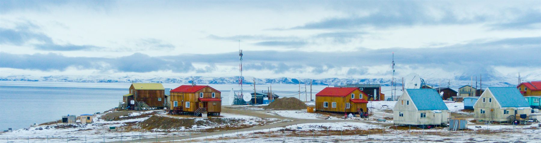 Colorful houses of an Arctic settlement on a snowy shore, Pond Inlet, Baffin Island